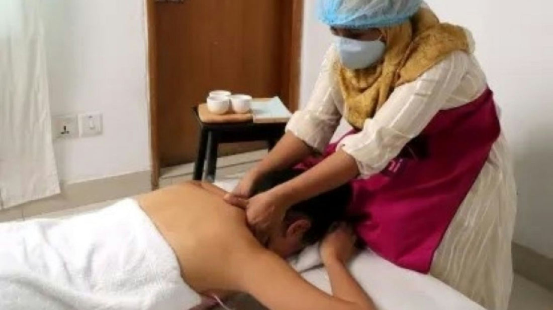 A person getting a back massage in a room